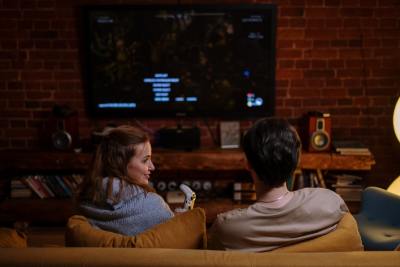 A couple watching netflix on the couch in their house