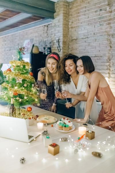 three girls doing a virtual christmas party 